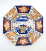 A Japanese octagonal plate in the Imari palette decorated with birds, flowers and foliage, with