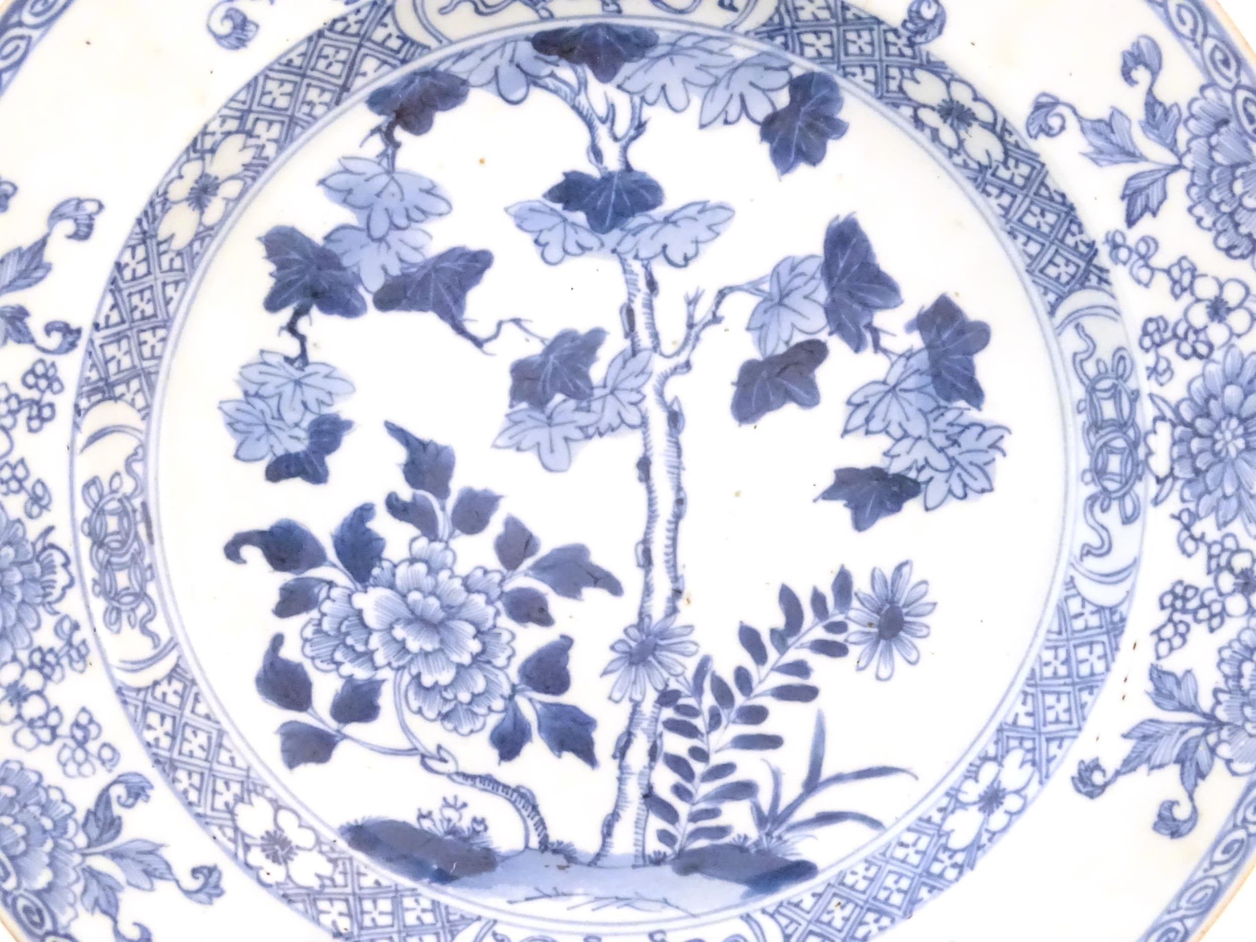 A Chinese blue and white plate decorated with flowers and foliage. With stylised motifs to - Image 5 of 5