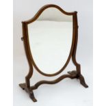 An early 20thC skeleton mirror with a shield shaped centre. 15" wide x 21" high. Please Note - we do