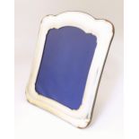 An Italian photograph frame with easel back and white metal surround . The whole 13 1/2" x 11"