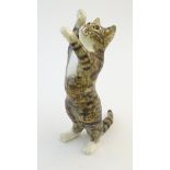 A Winstanley model of a standing cat. Marked under, size 5. Approx. 12 1/2" high Please Note - we do