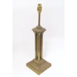 An early 20thC brass table lamp formed as a Corinthian cluster column, standing on a squared stepped