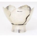 A Queen Elizabeth II silver bowl of stylised flower head / petal form with hammered decoration,