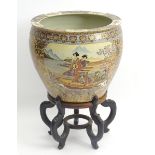 An Oriental planter / jardiniere decorated in the Satsuma style with Geisha girls on a boat with a