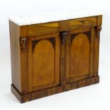 A mid 19thC marble topped cabinet with carved corbels and arched panelled doors with pierced