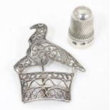 A silver thimble hallmarked Chester 1895. Together with a white metal brooch with filigree
