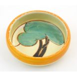 An Art Deco dish of circular form with hand painted tree decoration. Marked under 'Fantasque, Hand