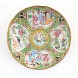 A Chinese / Cantonese plate decorated with figures, birds, butterflies, flowers, and scrolling