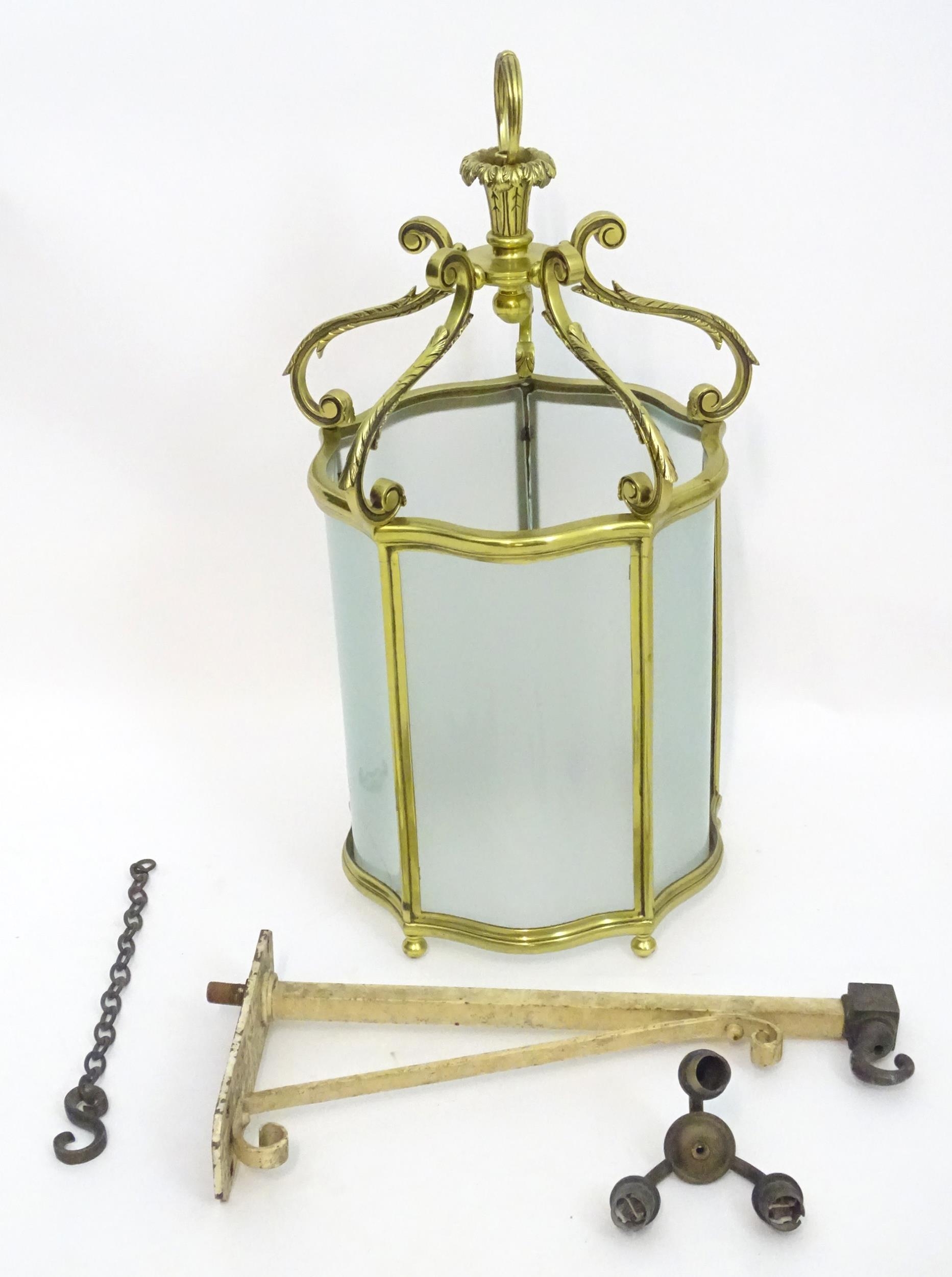 A 19thC brass hanging lantern and original bracket, the shade with five panels of frosted glass