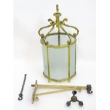 A 19thC brass hanging lantern and original bracket, the shade with five panels of frosted glass