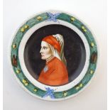 A small Italian dish of circular form depicting a portrait of Dante Alighieri with stylised wreath