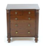 A small Regency mahogany chest / cupboard with turned reeded columns to the front above turned