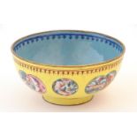 A Chinese / Cantonese famille jaune / yellow ground enamel bowl with roundel decoration depicting