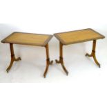 A pair of 19thC satinwood tables with crossbanded edges and an ebonised surround with marquetry