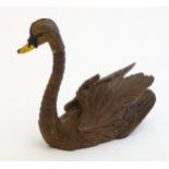 A 20thC black forest style carved pen holder modelled as a swan with an articulated neck. Approx.