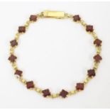 A 14ct gold bracelet set with garnets ( matching to lot 584) Please Note - we do not make
