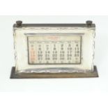 An Art Deco desk calendar with silver surround, hallmarked Birmingham 1927, maker WJ Myatt & Co.