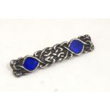 Alexander Ritchie - Iona Silver : A silver broch with Celtic decoration and blue enamel detail