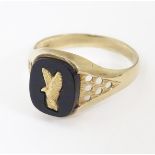 A 9ct gold and onyx signet ring. Ring approx size T Please Note - we do not make reference to the