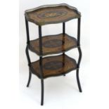 A Napoleon III ebonised etagere with marquetry satinwood detailing, having a pierced brass gallery