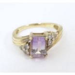 A 9ct gold ring set with amethyst and white topaz. Ring size approx. N Please Note - we do not