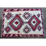 Carpet / Rug : A Qashqai kilim, the cream ground with red, blue and grey geometric decoration.