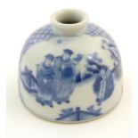 A Chinese blue and white ink pot of dome form decorated with scholars with scrolls in a landscape.