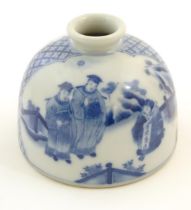 A Chinese blue and white ink pot of dome form decorated with scholars with scrolls in a landscape.