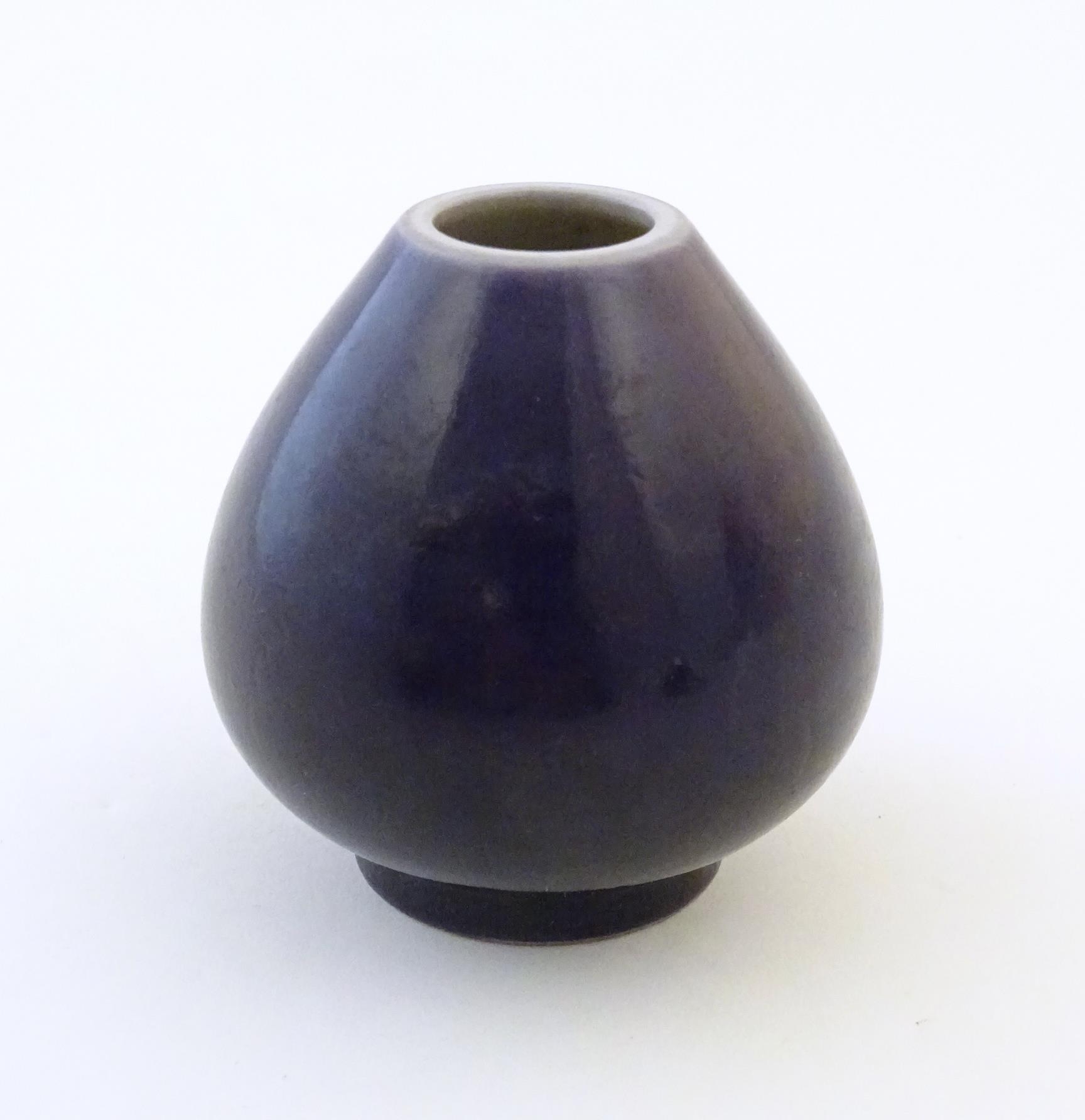 A small Chinese pot of teardrop form with an indigo glaze. Character marks under. Approx. 2" high - Image 4 of 6