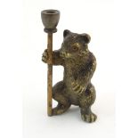 A novelty cold painted bronze model of a bear with a staff. Approx. 1 7/8" high Please Note - we