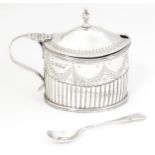 A Victorian silver mustard pot with fluted and bright cut decoration hallmarked London 1887, maker