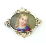 A brooch set with central oval cabochon with a hand painted portrait of a young girl within a yellow