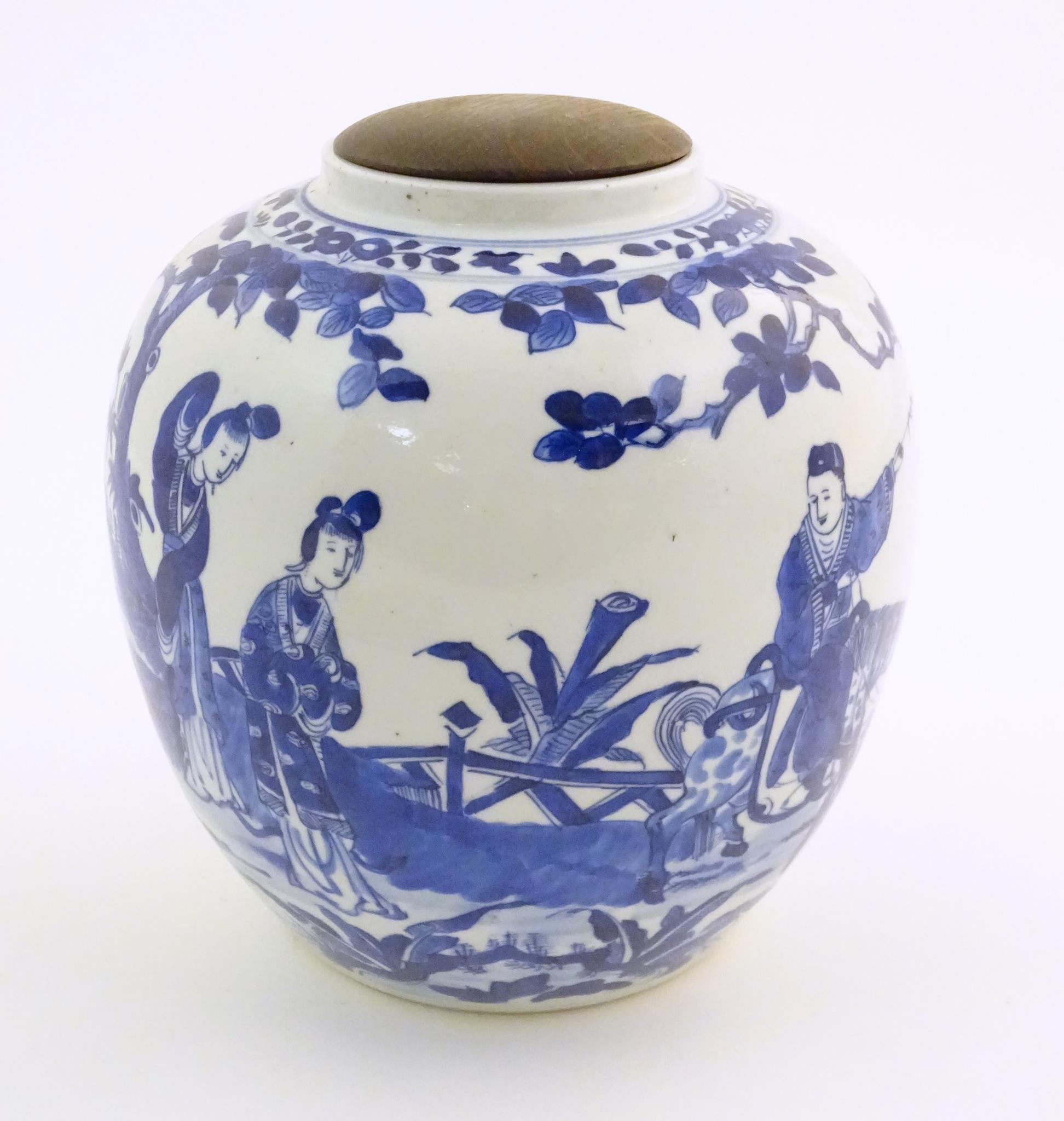 An Oriental blue and white ginger jar decorated with a landscape scene with a figure on horseback