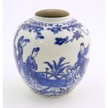 An Oriental blue and white ginger jar decorated with a landscape scene with a figure on horseback