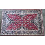 Carpet / Rug : A Kashan rug, the red, blue and cream grounds with stylised floral motifs. Approx. 86