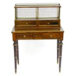 A Regency period rosewood bonheur du jour attributed to John Mclean, having a pierced brass