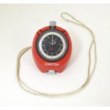 An Omega Stopwatch together with a red omega stopwatch case. Please Note - we do not make