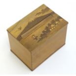 An Oriental cigarette dispensing box with marquetry / parquetry decoration to top depicting Mount