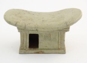 An Oriental stoneware neck pillow / headrest with architectural / building detail. Approx. 4 1/4"