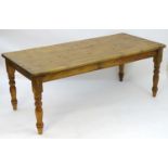 A mid / late 20thC pine farmhouse table stood on four large turned legs. 78" long x 36" wide x 30