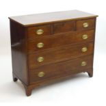 A Regency mahogany chest of drawers, with a rectangular reeded top above three short and three