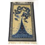 Carpets / Rugs : An Oriental rug depicting a stylised blue dragon above waves. Approx. 36" x 66"