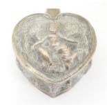 A white metal box of heart form with hinged lid and deity decoration. Possibly Indian . Approx. 2