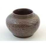 A small Chinese pot of squat form with cast landscape detail. Character marks under. Approx. 2 1/