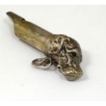 A silver plate novelty whistle with dog head decoration. Approx. 2 7/8" long Please Note - we do not