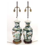 A pair of late 20thC Chinese ceramic famille verte table lamps with panelled decoration depicting
