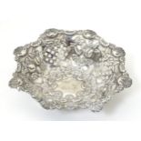 A silver pin dish with pierced and embossed decoration. Hallmarked Birmingham 1900 maker Miller