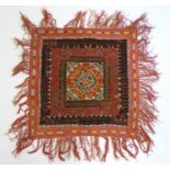 An embroidered patchwork textile panel of square form with stylised floral and foliate detail in the