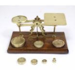 Late 19th / early 20thC brass postal balance scales with seven weights. Approx. 4 1/2" high x 10"