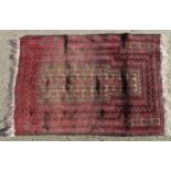 Carpet / Rug : A rug with red / pink ground and banded geometric decoration Approx. 54" x 35 1/2"